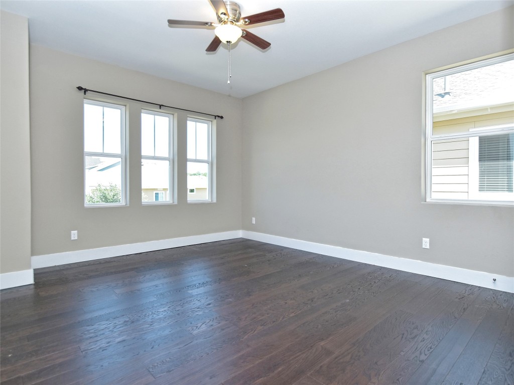 721 Clear Stream Crossing Austin, TX 78753 - Photo 21 of 24 a view of an empty room with wooden floor and a window