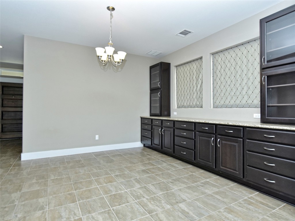 721 Clear Stream Crossing Austin, TX 78753 - Photo 6 of 24 a spacious bathroom with a granite countertop sink a mirror and a bathtub with shower