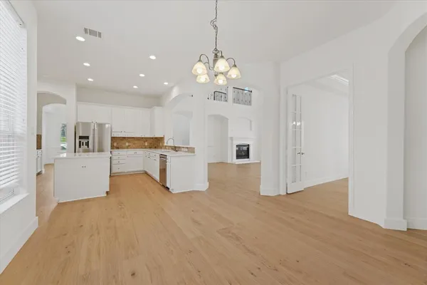 a view of a kitchen with wooden floor and a kitchen