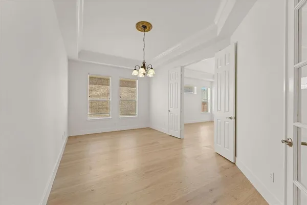 a view of a room with an entryway and chandelier