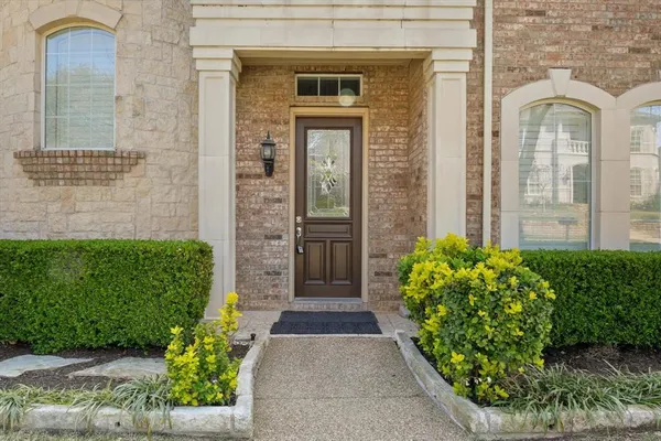 front view of a brick house with a large window