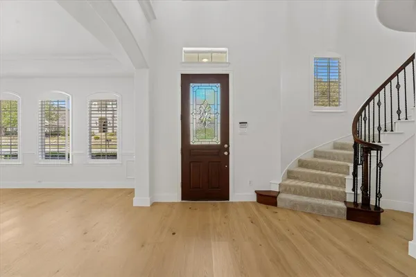 a view of an entryway with wooden floor and stairs