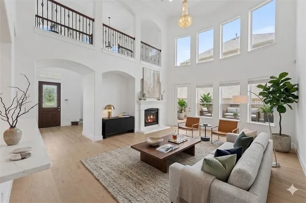 a living room with furniture fireplace and a table
