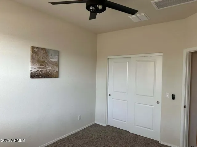 a view of a hallway with a ceiling fan