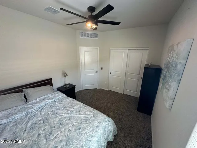 a bedroom with a bed and a walk in closet
