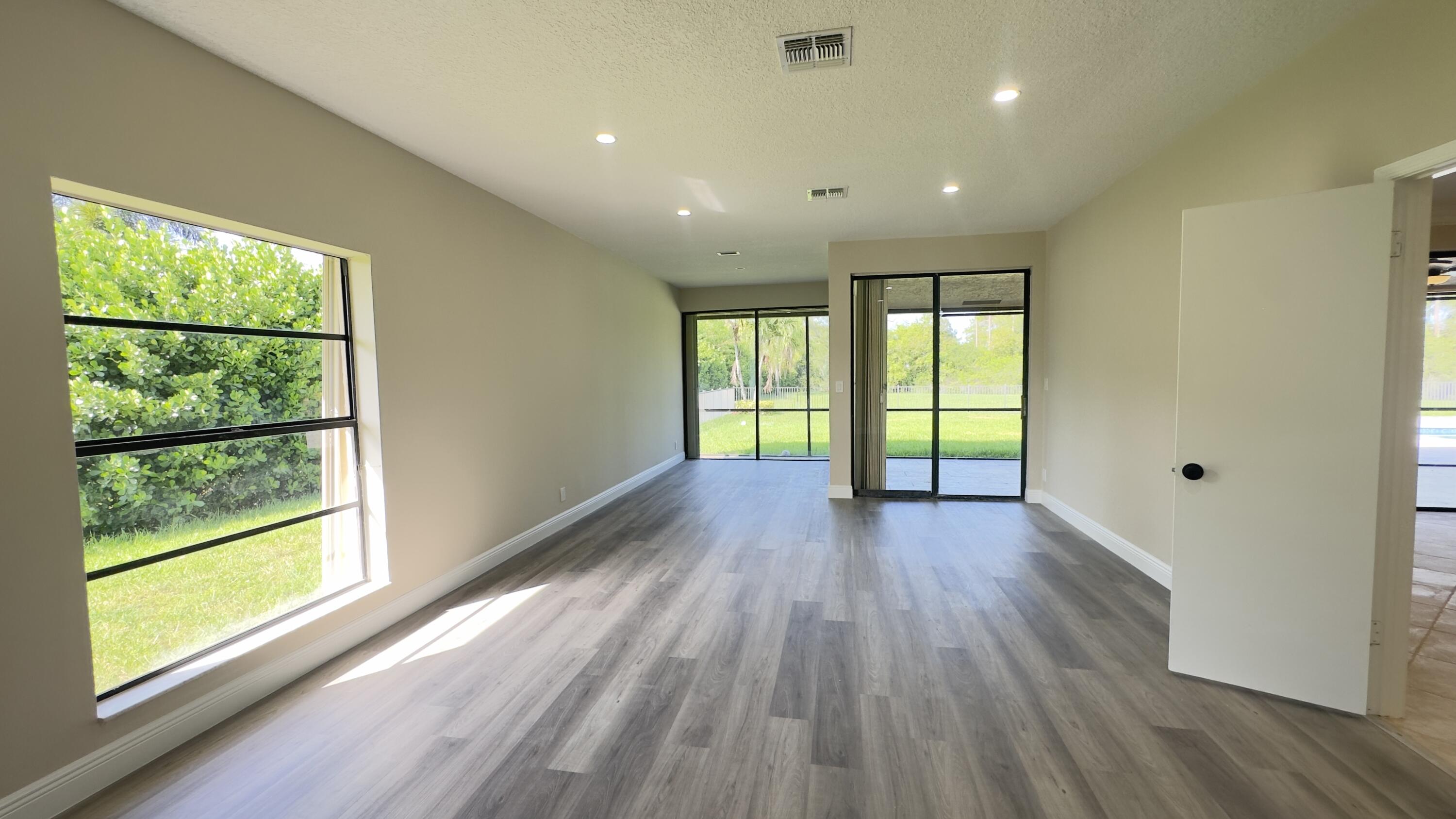 11330 Timber Lodge Terrace Boca Raton, FL 33428 - Photo 15 of 23 a view of hallway with a large window and wooden floor