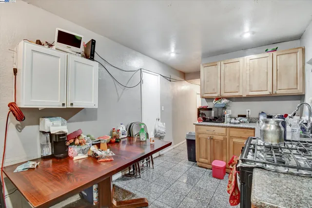 a kitchen with stainless steel appliances granite countertop a sink dishwasher stove top oven and cabinets