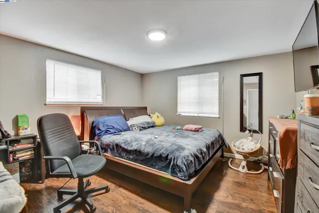 a bedroom with a bed chair and window