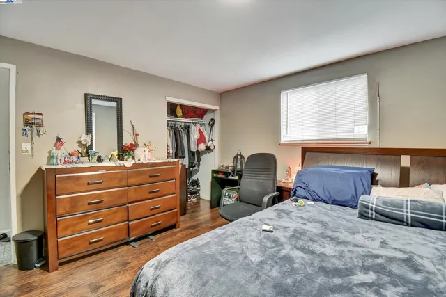 a bedroom with two beds and a dresser