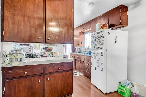 a kitchen with a refrigerator and a sink