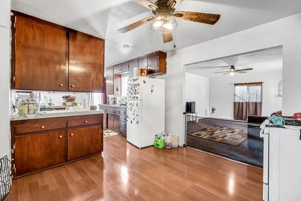 a living room with a bed furniture and a flat screen tv