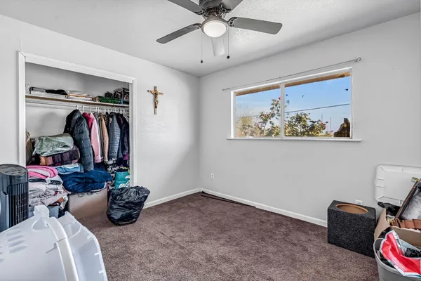 a bedroom with a bed and a large window