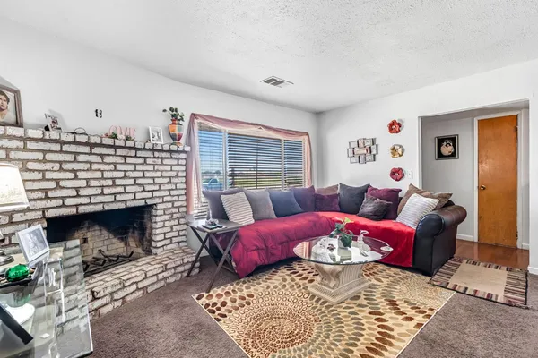 a living room with furniture a window and a fireplace