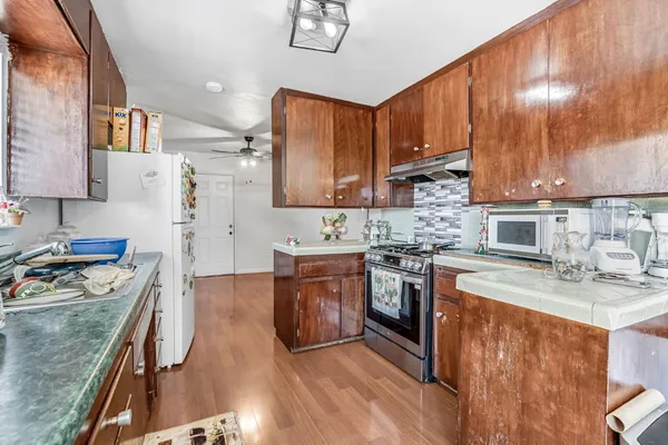 a kitchen with a stove a sink and a microwave