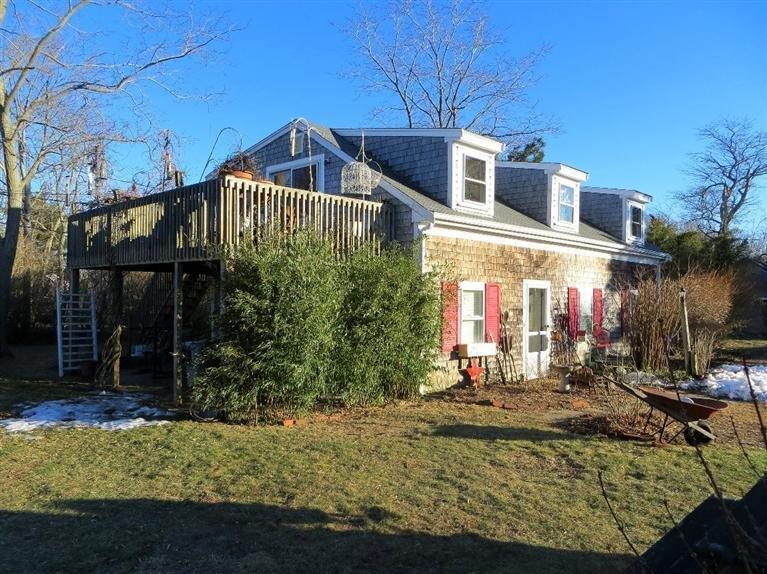 137 Rock Harbor Road, Unit 5 Orleans, MA 02653 - Photo 1 of 13 a front view of a house with garden