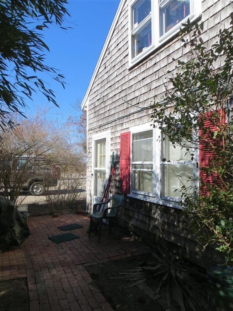 137 Rock Harbor Road, Unit 5 Orleans, MA 02653 - Photo 2 of 13 a view of a house with a yard