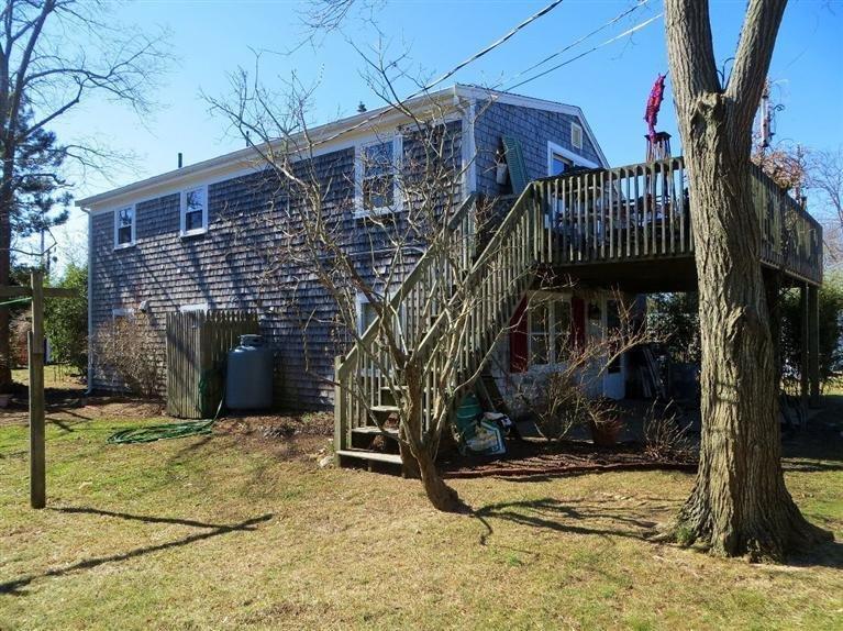 137 Rock Harbor Road, Unit 5 Orleans, MA 02653 - Photo 3 of 13 a view of a house with a yard
