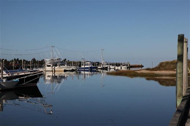 137 Rock Harbor Road, Unit 5 Orleans, MA 02653 - Photo 8 of 13 a view of a lake with boats and trees