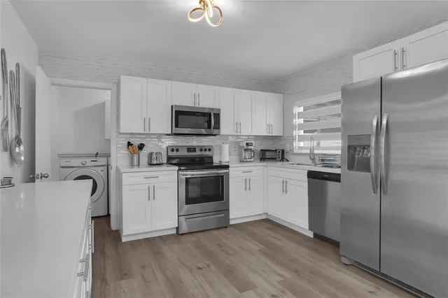 a kitchen with a refrigerator stove and sink