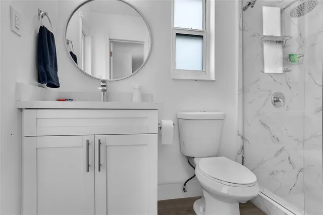a bathroom with a toilet sink and mirror