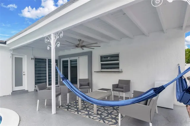 a swimming pool with outdoor seating and yard