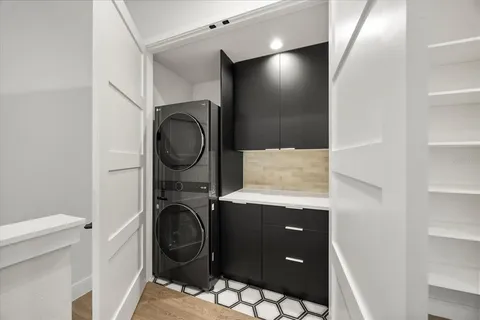 a bedroom with a bed a large window and flat screen tv