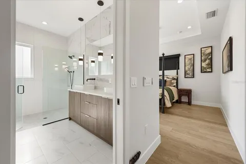 a bathroom with a double vanity sink mirror and shower