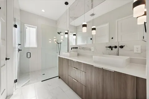 a bathroom with a shower sink and mirror