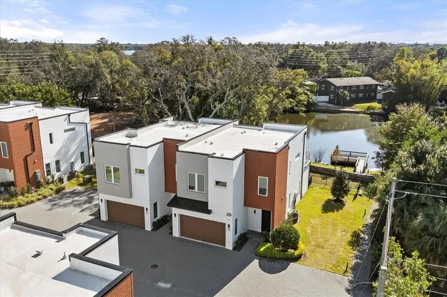 an aerial view of a house with a swimming pool and outdoor seating