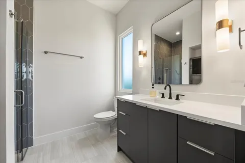 a spacious bedroom with a bed and a lamp