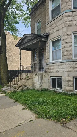 a front view of a house with a garden and plants