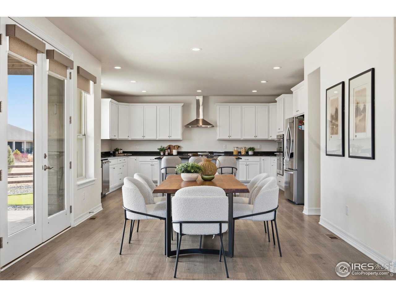 6402 Foothills View Place Fort Collins, CO 80528 - Photo 4 of 50 a kitchen with a dining table chairs and refrigerator