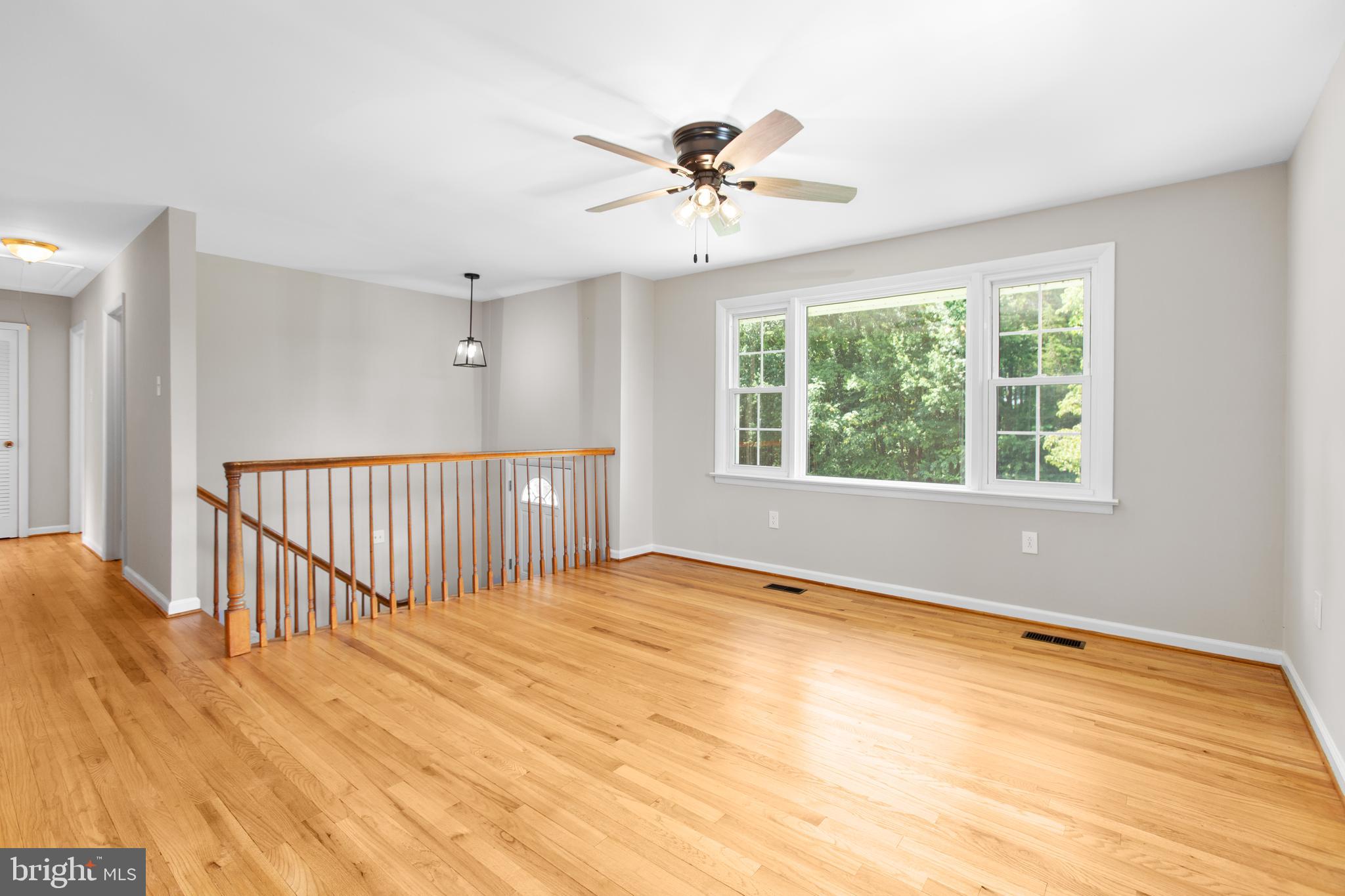 18136 Pepmeier Hill Road Fredericksburg, VA 22408 - Photo 14 of 80 a view of an empty room with wooden floor and a window