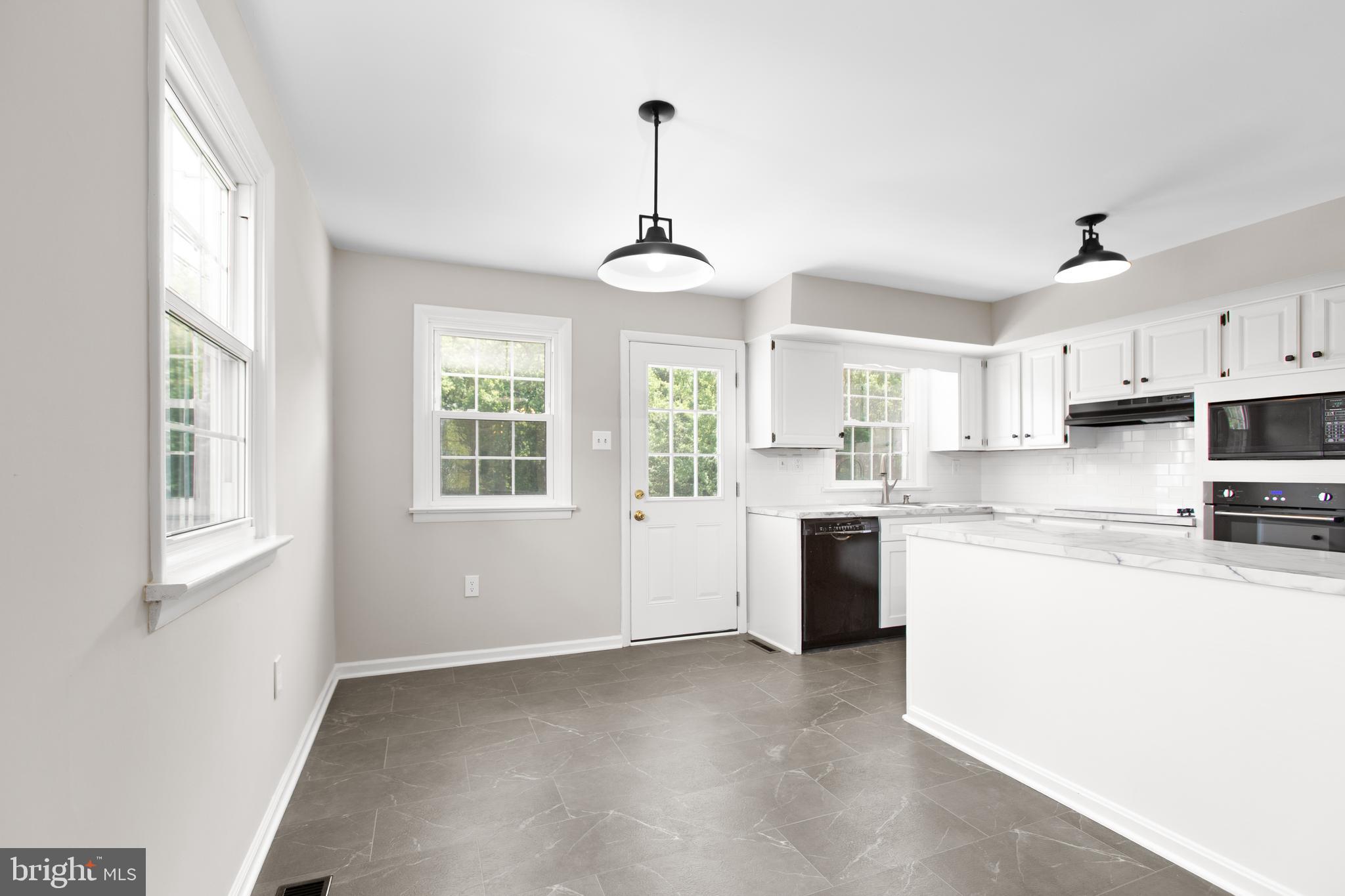18136 Pepmeier Hill Road Fredericksburg, VA 22408 - Photo 16 of 80 a kitchen with stainless steel appliances granite countertop a stove a sink dishwasher a refrigerator and white cabinets with wooden floor