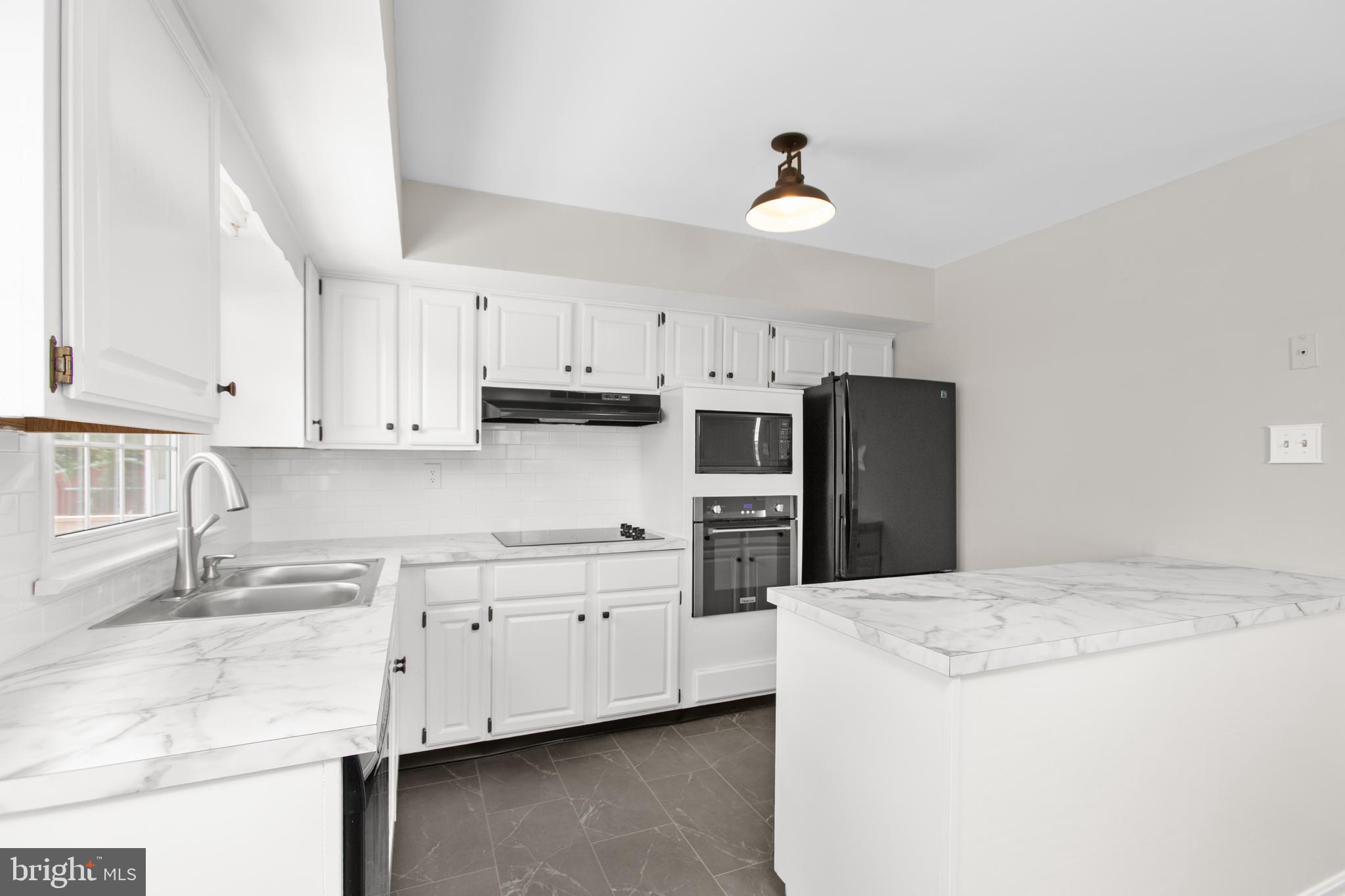 18136 Pepmeier Hill Road Fredericksburg, VA 22408 - Photo 18 of 80 a kitchen that has a cabinets and appliances
