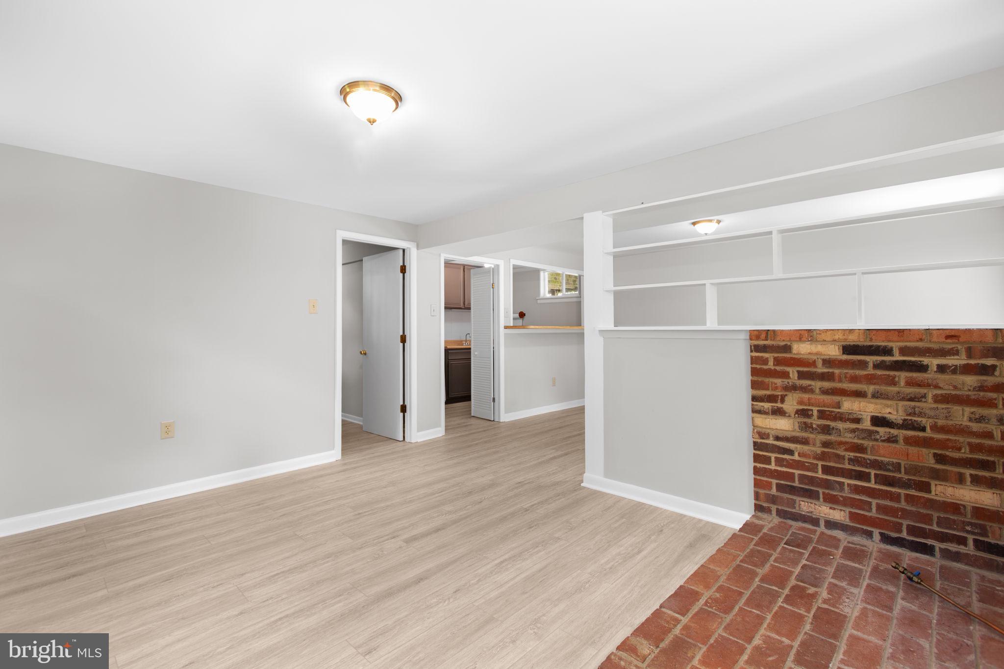 18136 Pepmeier Hill Road Fredericksburg, VA 22408 - Photo 37 of 80 a view of an empty room with wooden floor and windows