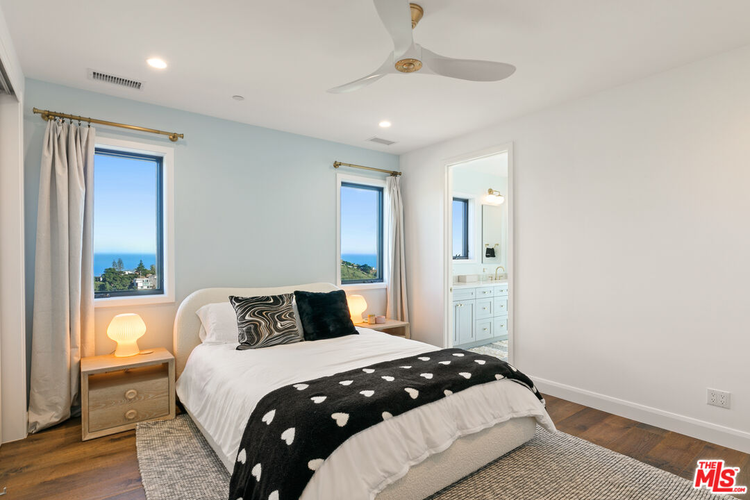 27148 Carrita Road Malibu, CA 90265 - Photo 15 of 27 a bedroom with a large bed and wooden floor
