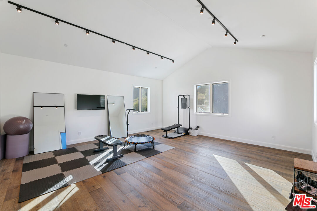 27148 Carrita Road Malibu, CA 90265 - Photo 17 of 27 a view of a room with gym equipment and windows