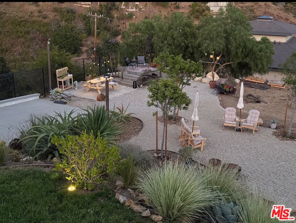 27148 Carrita Road Malibu, CA 90265 - Photo 18 of 27 a view of a backyard with plants and swimming pool