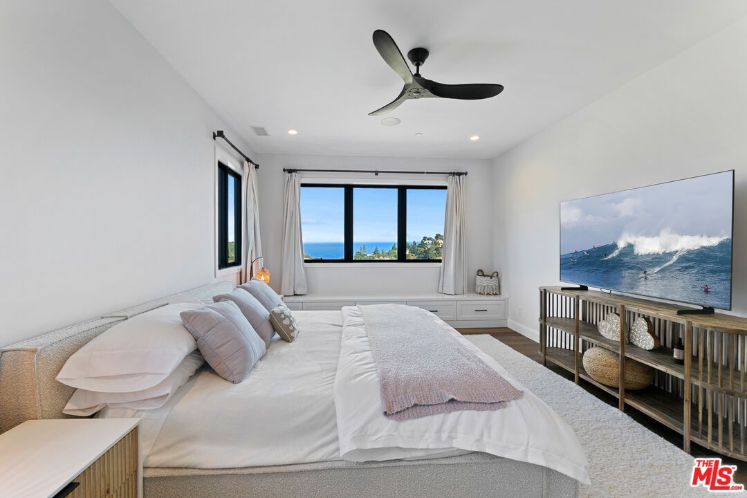 27148 Carrita Road Malibu, CA 90265 - Photo 10 of 27 a bedroom with a bed and a large window