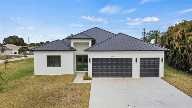 a front view of a house with a yard and garage