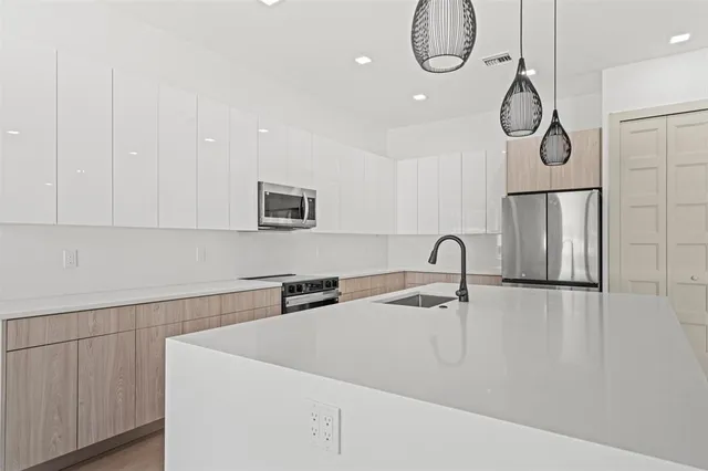 a kitchen with a sink and cabinets