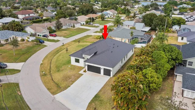 an aerial view of a house with a swimming pool