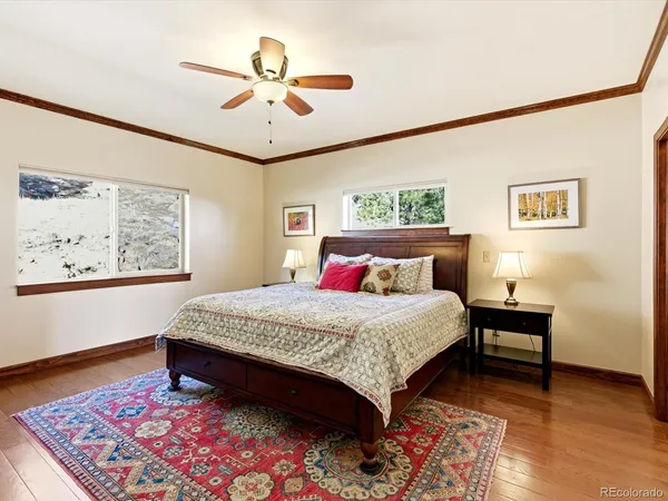 a bedroom with a bed and a painting on the wall