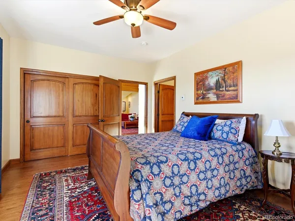 a large bedroom with a bed and a chandelier
