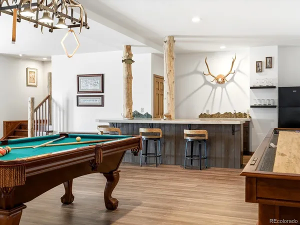 a room with pool table and windows