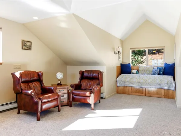 a bedroom with furniture and a large window