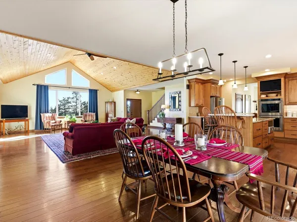 a view of a dining room with furniture window and wooden floor