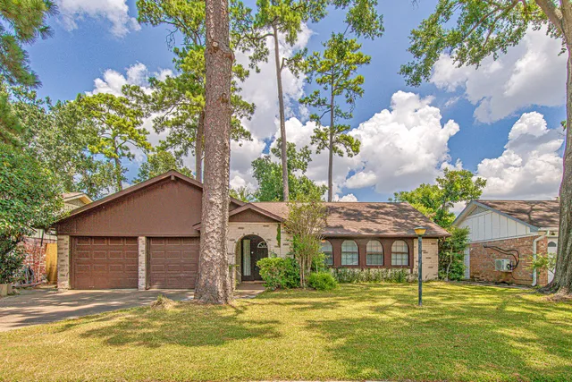 a house with a big yard and large trees