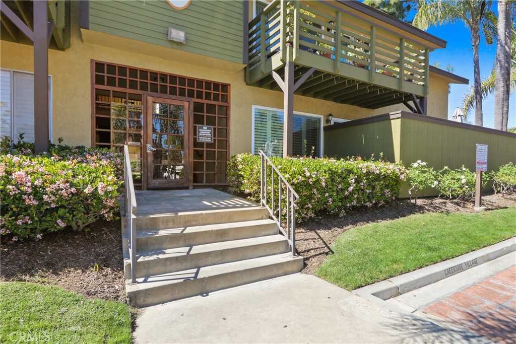 a view of a house with a yard and sitting area
